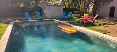 a pool with chairs and a toy in the water at Mazet in Rognes