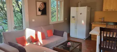a living room with a couch and a refrigerator at Mazet in Rognes