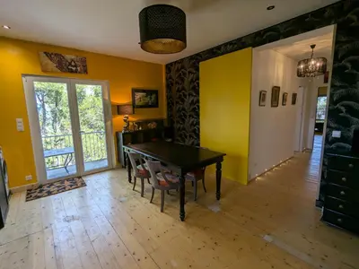 a dining room with a ping pong table and yellow walls at Charme, vue et piscine naturelle in Vedène