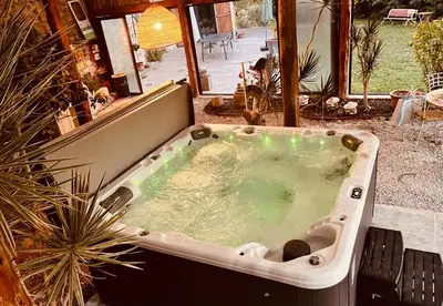 a jacuzzi tub in a yard with a patio at Évasion charme et jacuzzi en pleine nature in Grans