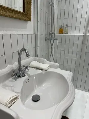 a white sink with a faucet in a bathroom at Studio centre ville la Toscane in LʼIsle-sur-la-Sorgue