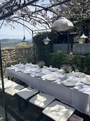 a long white table with plates and glasses on it at Village home in Ménerbes in Ménerbes