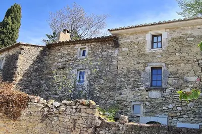 an old stone building with a stone wall at Village home in Ménerbes in Ménerbes