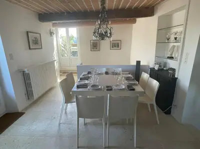 a dining room with a table with chairs and a chandelier at Village home in Ménerbes in Ménerbes