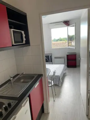 a small kitchen with a sink and a microwave at Joli appartement sur Aix-en-Provence in Aix-en-Provence