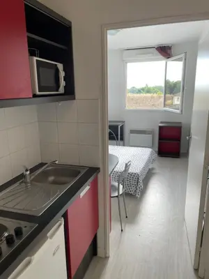 a small kitchen with a sink and a microwave at Joli appartement sur Aix-en-Provence in Aix-en-Provence