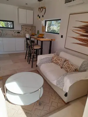 a living room with a couch and a table at Gîte en Provence pour amoureux de la nature in Rognes