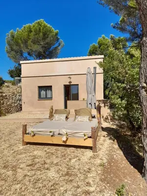 a bed in front of a house at Gîte en Provence pour amoureux de la nature in Rognes