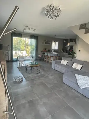 a living room with a couch and a table at Chaleureuse maison in Cavaillon