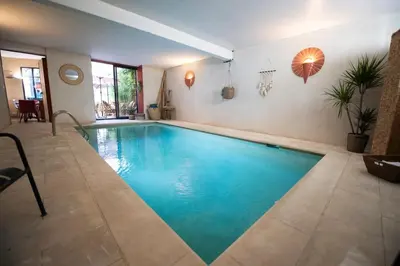 a large swimming pool in a living room at La Maison Clémenceau in Salon-de-Provence