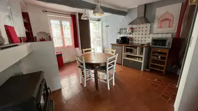 a kitchen with a table and chairs in a room at Charmante petite maison à Murs in Murs