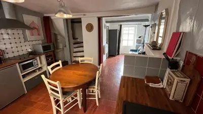 a kitchen and dining room with a table and chairs at Charmante petite maison à Murs in Murs