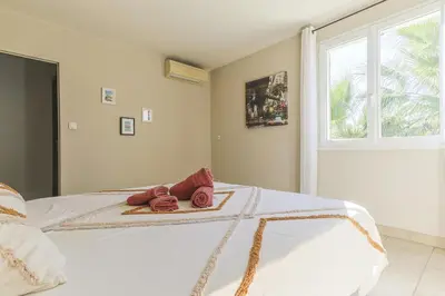 a bedroom with a bed with red shoes on it at Source de Vie in Noves