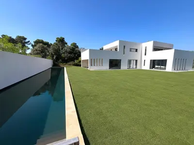 a large white house with a lawn and a swimming pool at Belvédère Sainte Victoire in Saint-Marc-Jaumegarde