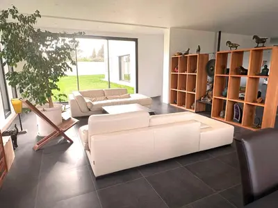 a living room with white furniture and a potted plant at Belvédère Sainte Victoire in Saint-Marc-Jaumegarde