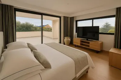 a bedroom with a large bed and a flat screen tv at Belvédère Sainte Victoire in Saint-Marc-Jaumegarde