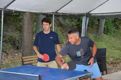 two men standing around a ping pong table at Moulin des Gypses Gîte Les Pampres, Ventoux in Mormoiron