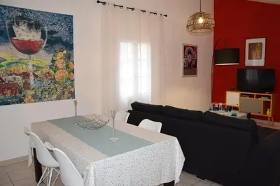 a living room with a table and a couch at Moulin des Gypses Gîte l'Oliveraie, Ventoux in Mormoiron