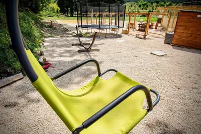 a green slide in a park with a playground at Appartement charmant près du centre d'Avignon, 60m², piscine in Avignon