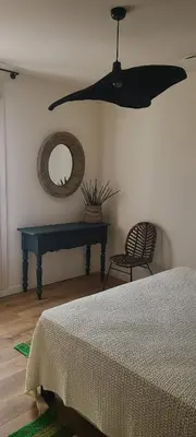 a bedroom with a bed and a mirror and a table at Cycle , Cook and Relax in Caromb