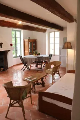 a living room with a table and chairs at Mas Provencal Monteux 84170 in Althen-des-Paluds