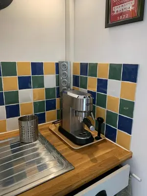 a kitchen counter with a coffee maker on a counter top at Maison du vallon de Galeye in La Roque-sur-Pernes