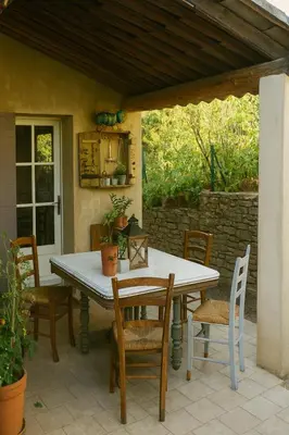 a white table and chairs on a patio at Le Cabanon Provençal Traditionnel Jardin Barbecue & Cheminée in Saumane-de-Vaucluse