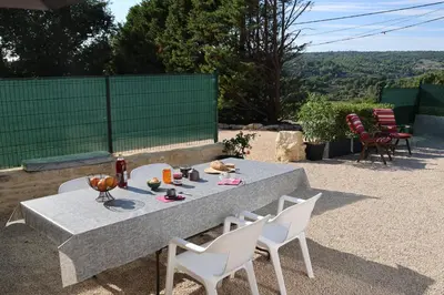 a table and chairs with food and drinks on it at Les Vignes du Luberon in Saignon