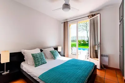 a bedroom with a bed and a large window at Villa-Provence-Pont-Royal in Mallemort