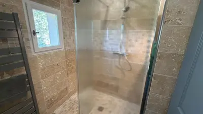 a shower with a glass door in a bathroom at Villa-Provence-Pont-Royal in Mallemort