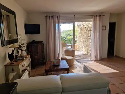 a living room with a couch and a table at Le Bastidon des Mésanges in Gordes