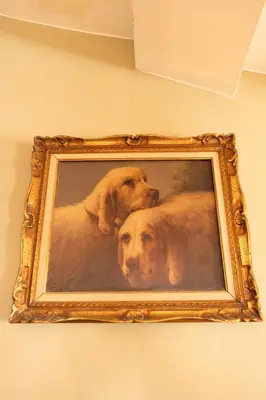a painting of a dog in a gold frame at Loft COSY et luxueux, HYPER-CENTRE in Aix-en-Provence