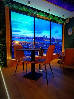 a dining room with a table and chairs and a large window at Multiverse Suite immersive in Charleval