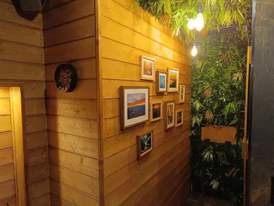 a wooden wall with pictures on it at Multiverse Suite immersive in Charleval