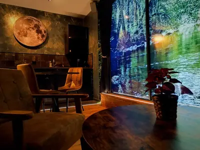 a living room with a table and a large window at Multiverse Suite immersive in Charleval