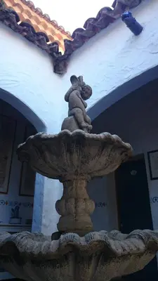a statue of a koala sitting on top of a fountain at B&B Villa Chante Coucou in Fontaine-de-Vaucluse