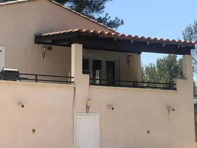 a house with a balcony on top of it at B&B Villa Chante Coucou in Fontaine-de-Vaucluse