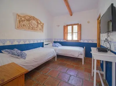 a room with two beds and a desk in it at B&B Villa Chante Coucou in Fontaine-de-Vaucluse