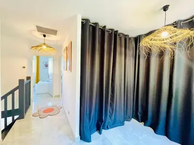 a hallway with black curtains in a room at Maison haut de gamme dans le golf de pont royal in Mallemort