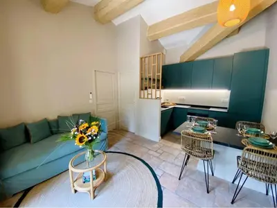 a living room with a couch and a table and chairs at Mazet Rigodon Alpilles in Eygalières