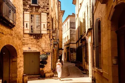 a woman walking down a street in an alley at Mazet Rigodon Alpilles in Eygalières