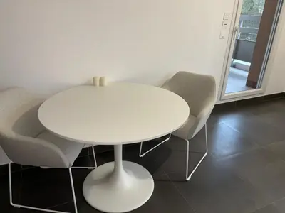 a white table and chairs in a room at Appartement T2 climatisé garage in Aix-en-Provence