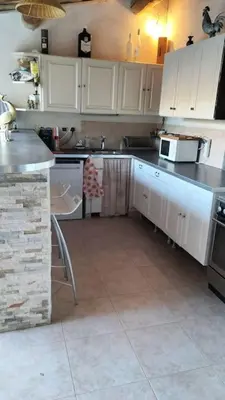 a kitchen with white cabinets and a counter top at le 1387 l'étape en Provence in Plan-dʼOrgon