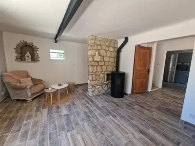 a living room with a stone fireplace and a couch at Nel Home in Mazan