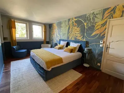 a bedroom with a bed and a painting on the wall at Bastide Farandole in Eygalières