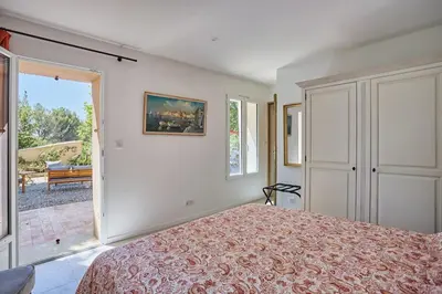 a bedroom with a bed and a large window at Le Bastidon, Aix en Pce proche centre, climatisé, 4 chambres in Aix-en-Provence
