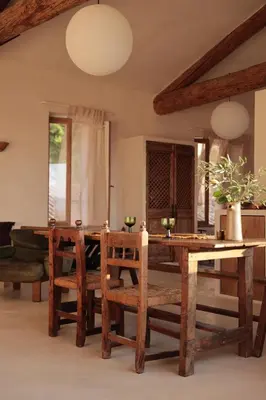 a dining room with a wooden table and chairs at Casa Pauseto in Bonnieux