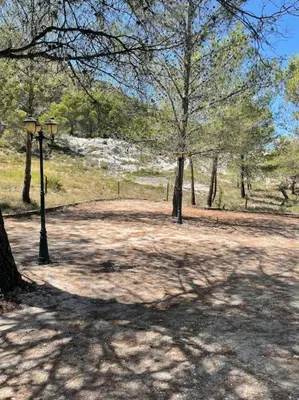 a park with a street light and trees in a park at Mazet Cordelles Alpilles in Eygalières