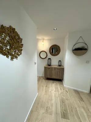 a room with white walls and wooden floors and mirrors at Duplex rénové comme Neuf à Aix-en-Provence in Aix-en-Provence