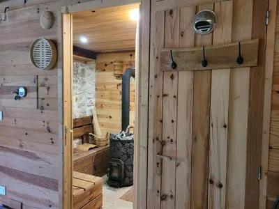 a log cabin with a door leading to a stove at Ecolieu Silenciane in Simiane-la-Rotonde
